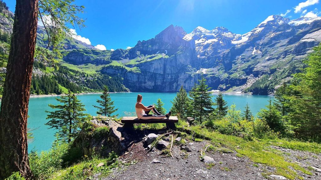 oeschinensee girl sitting on the bench overlooking the lake